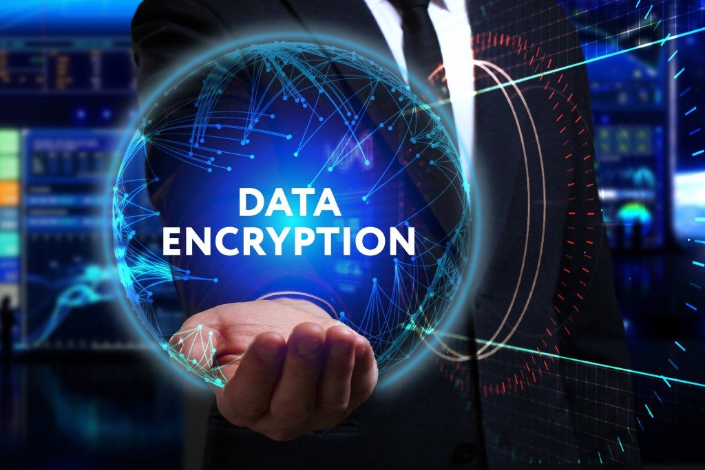 businessman holding digitalized data encryption