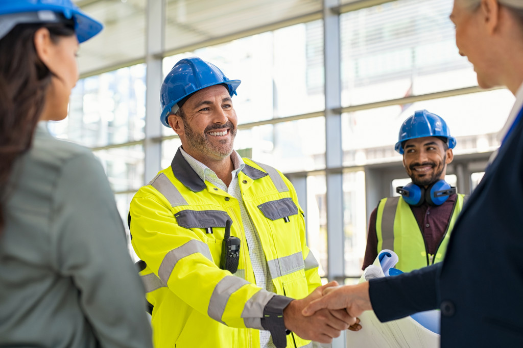 construction people shaking hands with other professionals