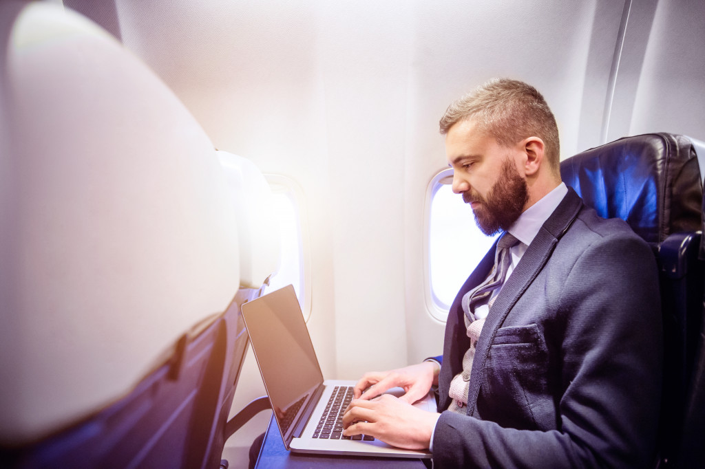 businessman on a plane working