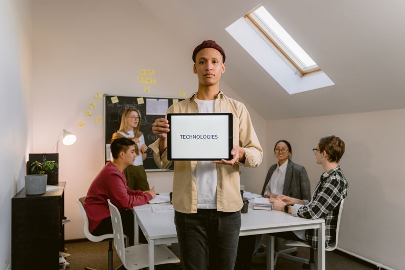 a man holding a sign with the word "technologies" written on it